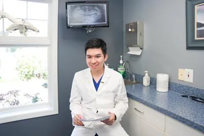 Dr. Nguyen discussing dental implants with a patient at his office Conyers Family Dentist