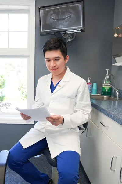 Dr. Nguyen reviewing charts of a pediatric patient at Conyers Family Dentist